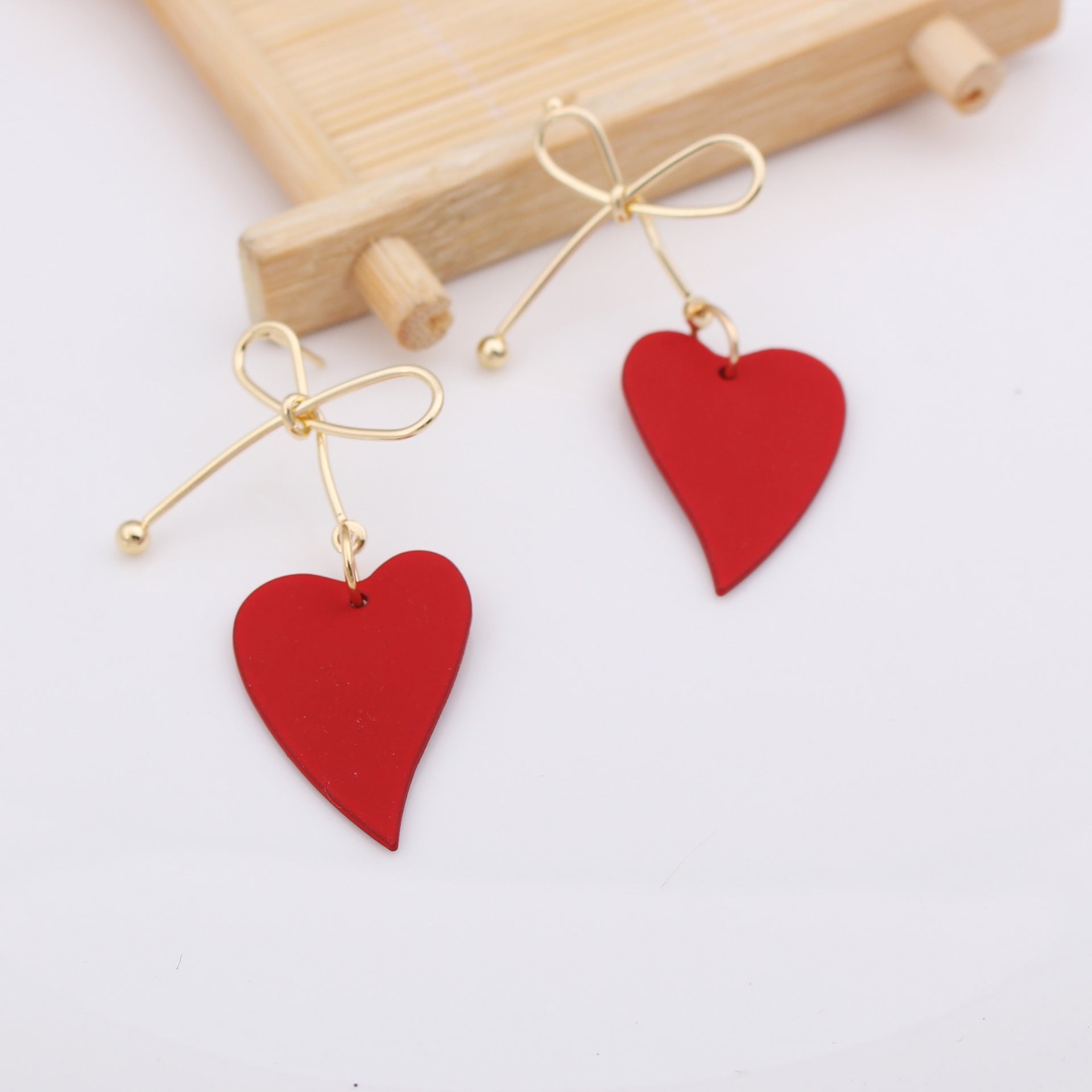 Boucles d'oreilles nœud papillon doré avec pendentif cœur rouge élégantes Moyyudé