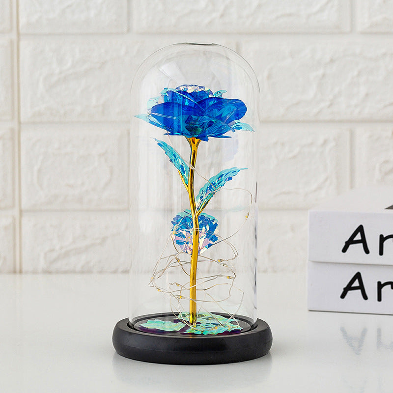 Rose Eternelle Cloche Verre bleue avec tige dorée sous cloche en verre sur socle noir