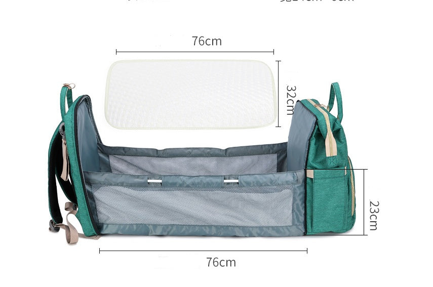 Sac A Langer Avec Lit Intégré Moyyudé en vert avec dimensions montrant le lit déplié pour bébé